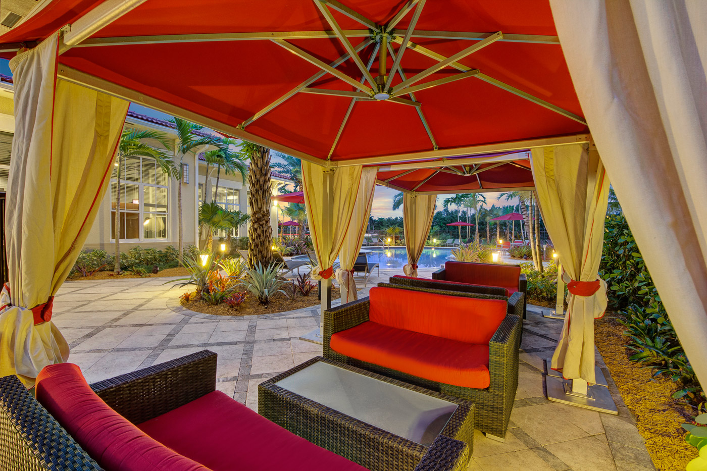 Outdoor poolside lounge seating area at apartment community